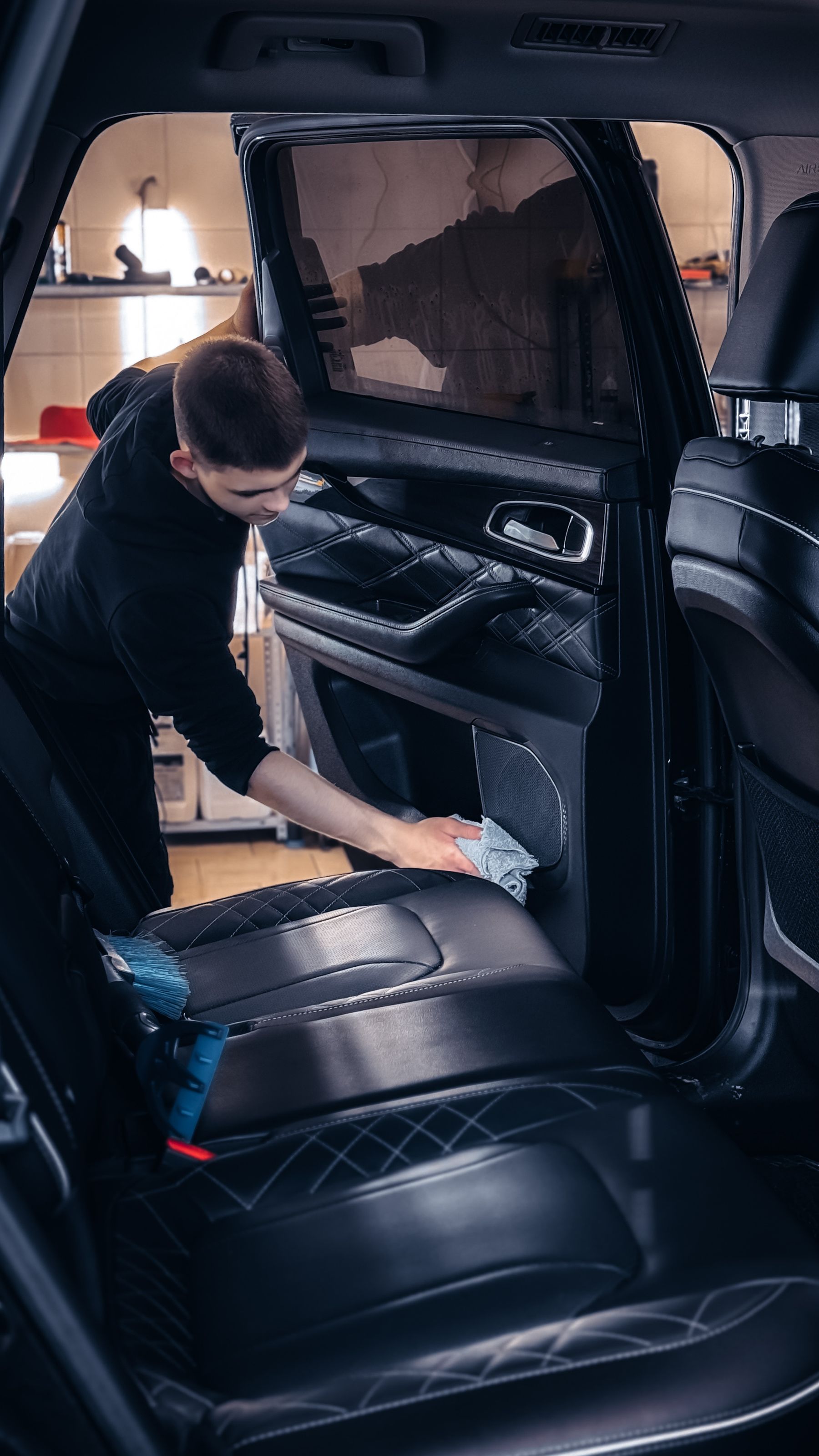 A vehicle interior being wiped during professional cleaning